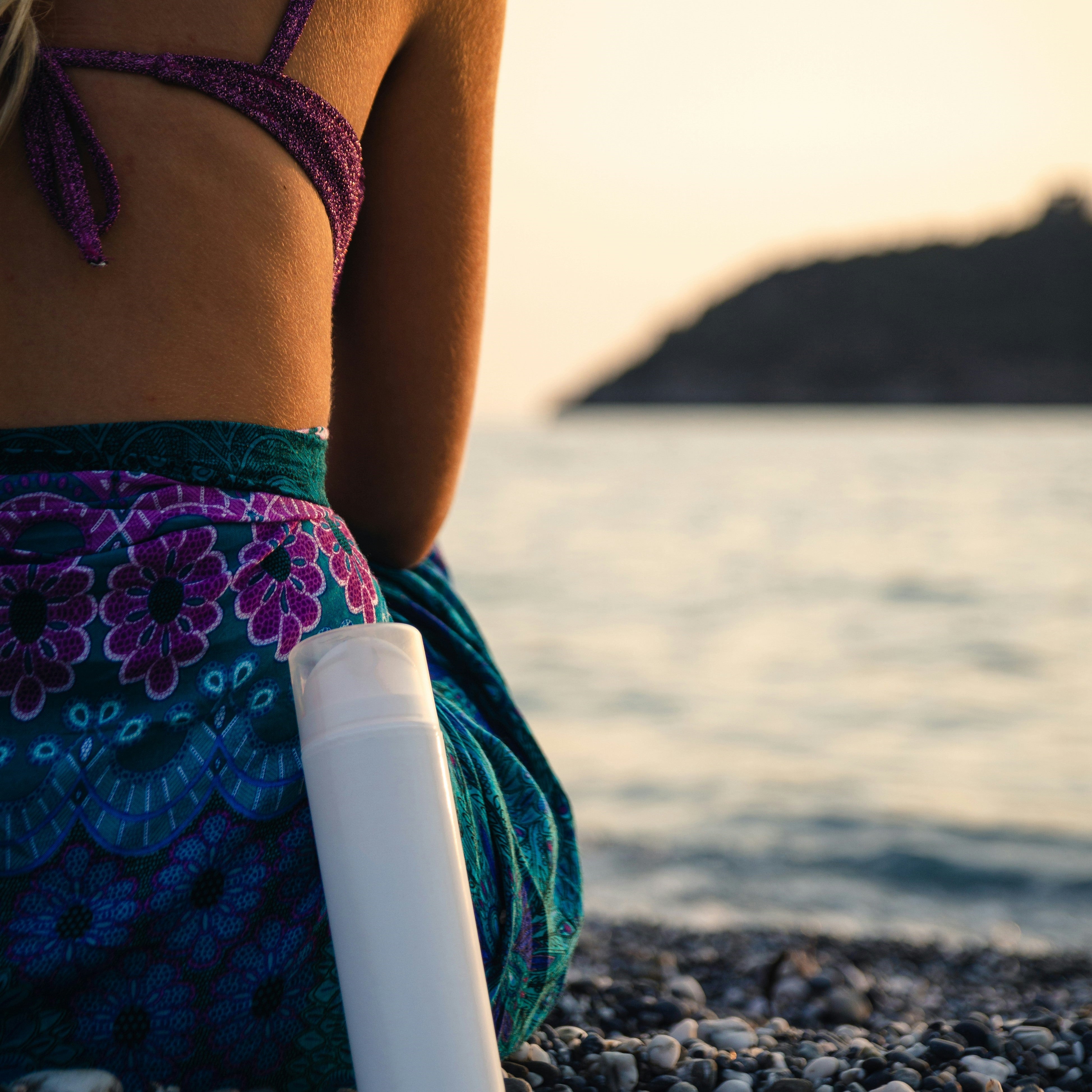 Woman on the beach with sunscreen