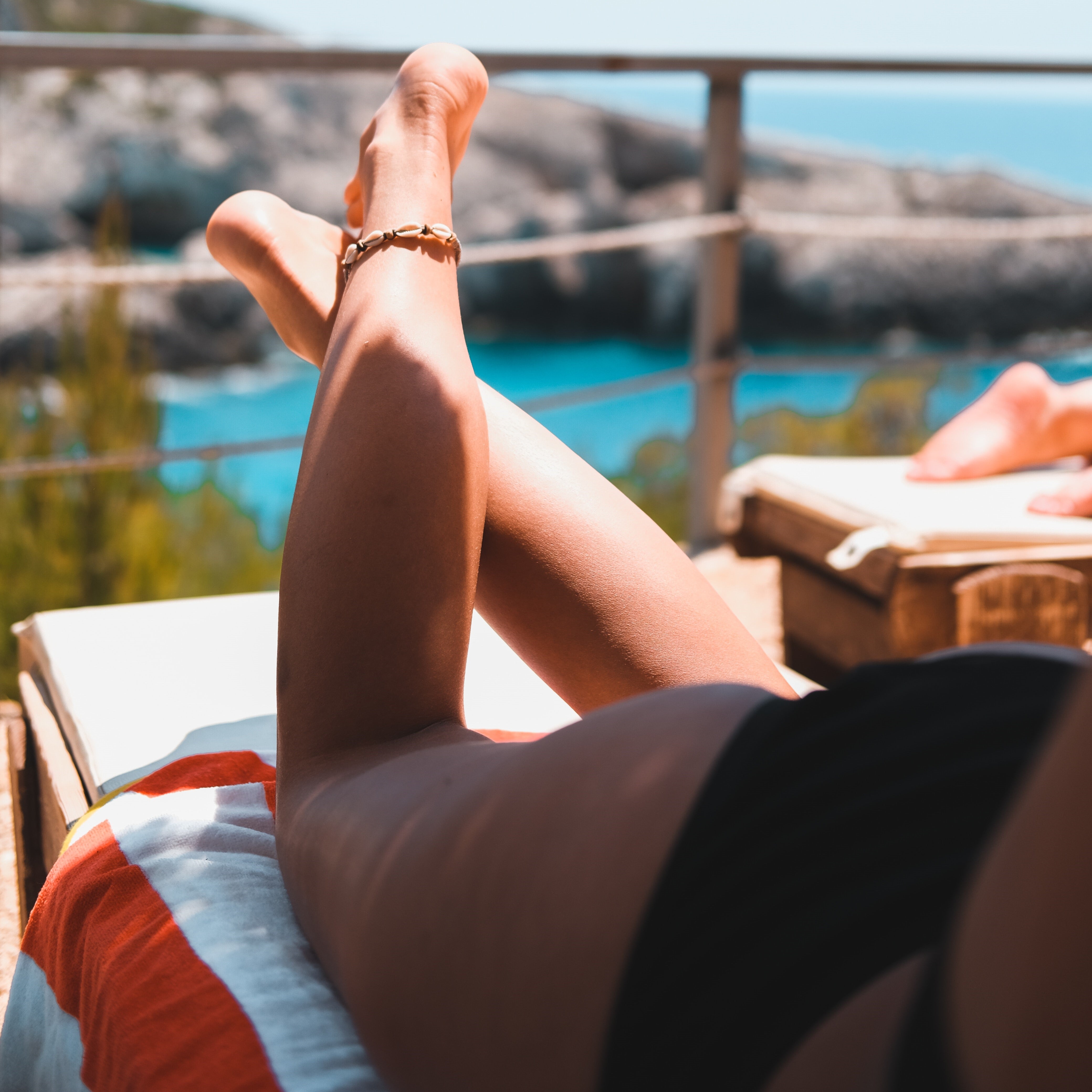 Woman sun bathing with shade