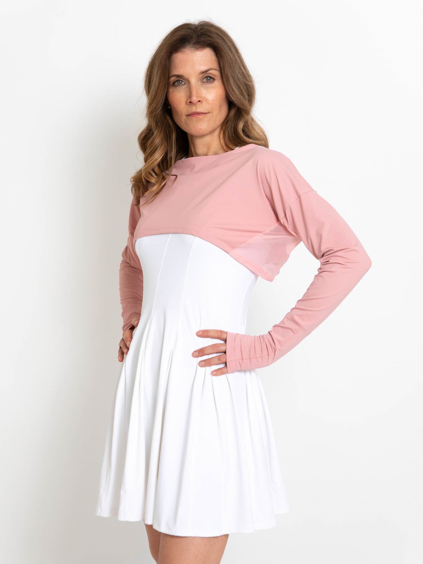 Woman wearing pink lightweight UPF 50+ (sun-protective) crop top with hand protection.